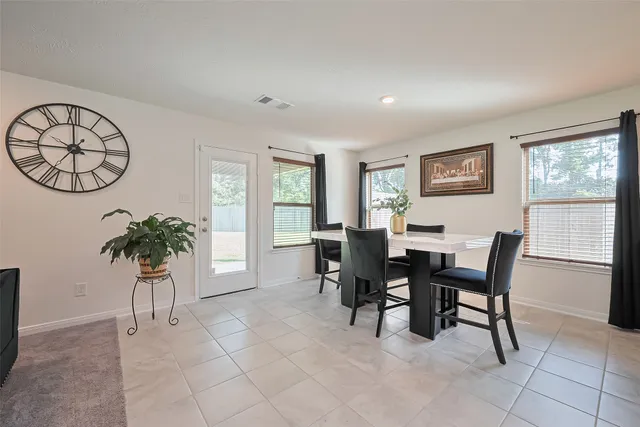 a view of a dining room with furniture and a potted plant