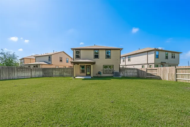 a view of a house with a yard and sitting area