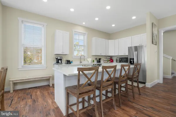 a kitchen with a table chairs refrigerator and cabinets