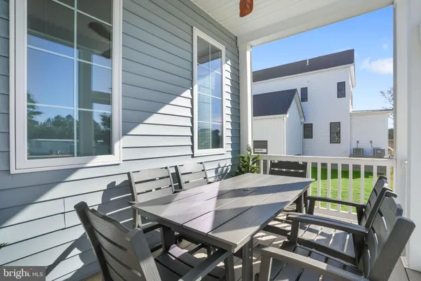 a dining room with furniture and a large window
