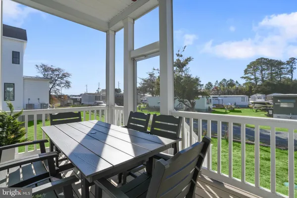 a view of a city from a balcony with furniture