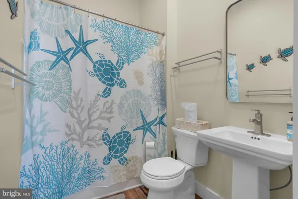 a bathroom with a sink and mirror with toilet