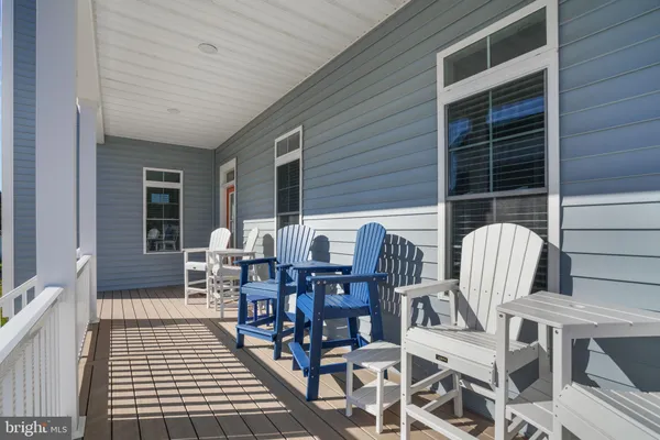a view of a dining table and chairs in the balcony
