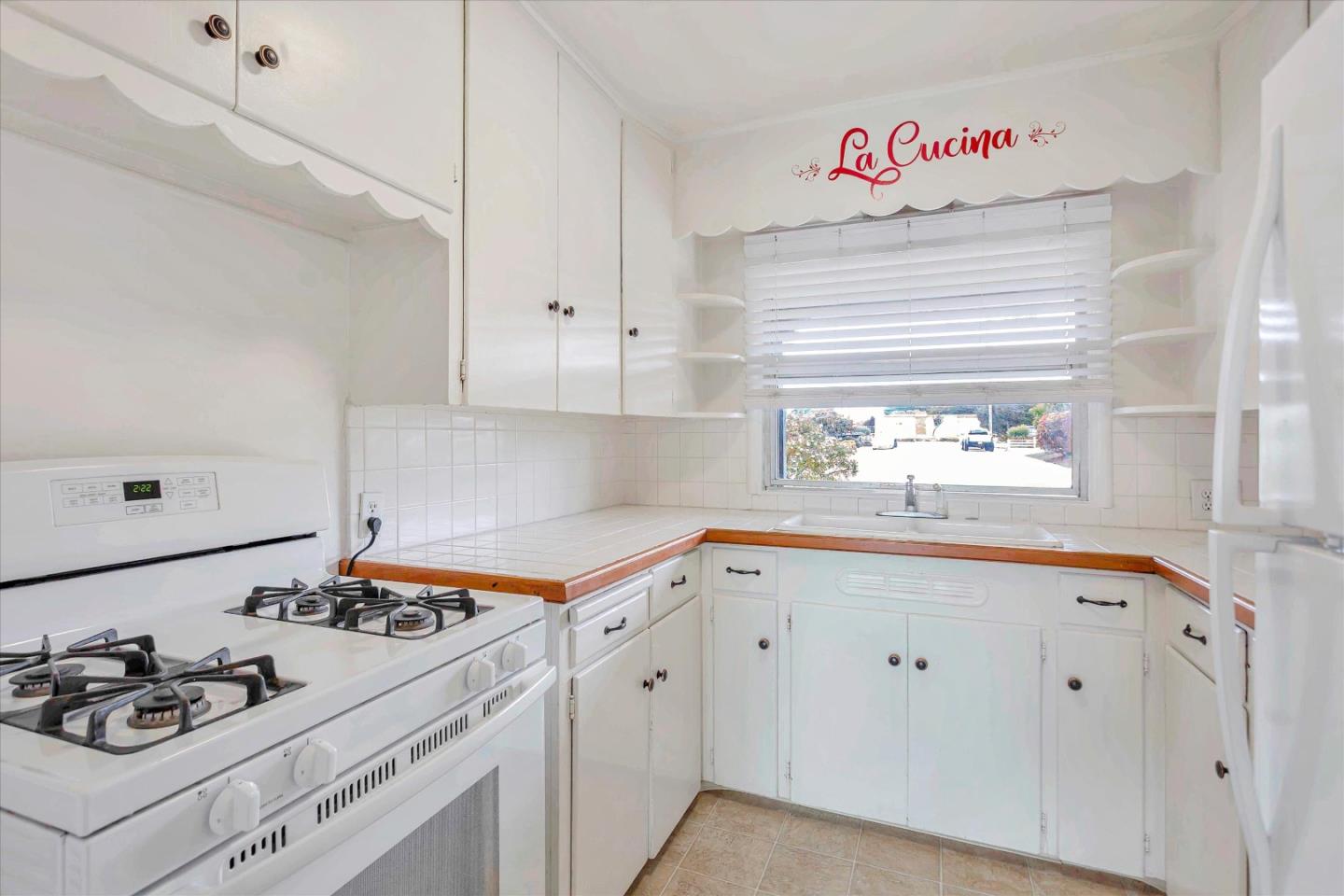 950 Portola Drive Del Rey Oaks, CA 93940 - Photo 9 of 37 a kitchen with white cabinets stove and sink