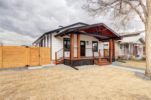 a view of a house with wooden fence