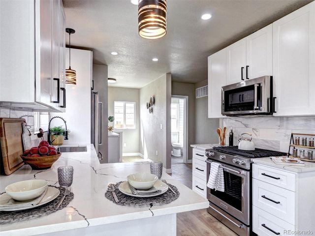a kitchen with a sink stainless steel appliances and cabinets