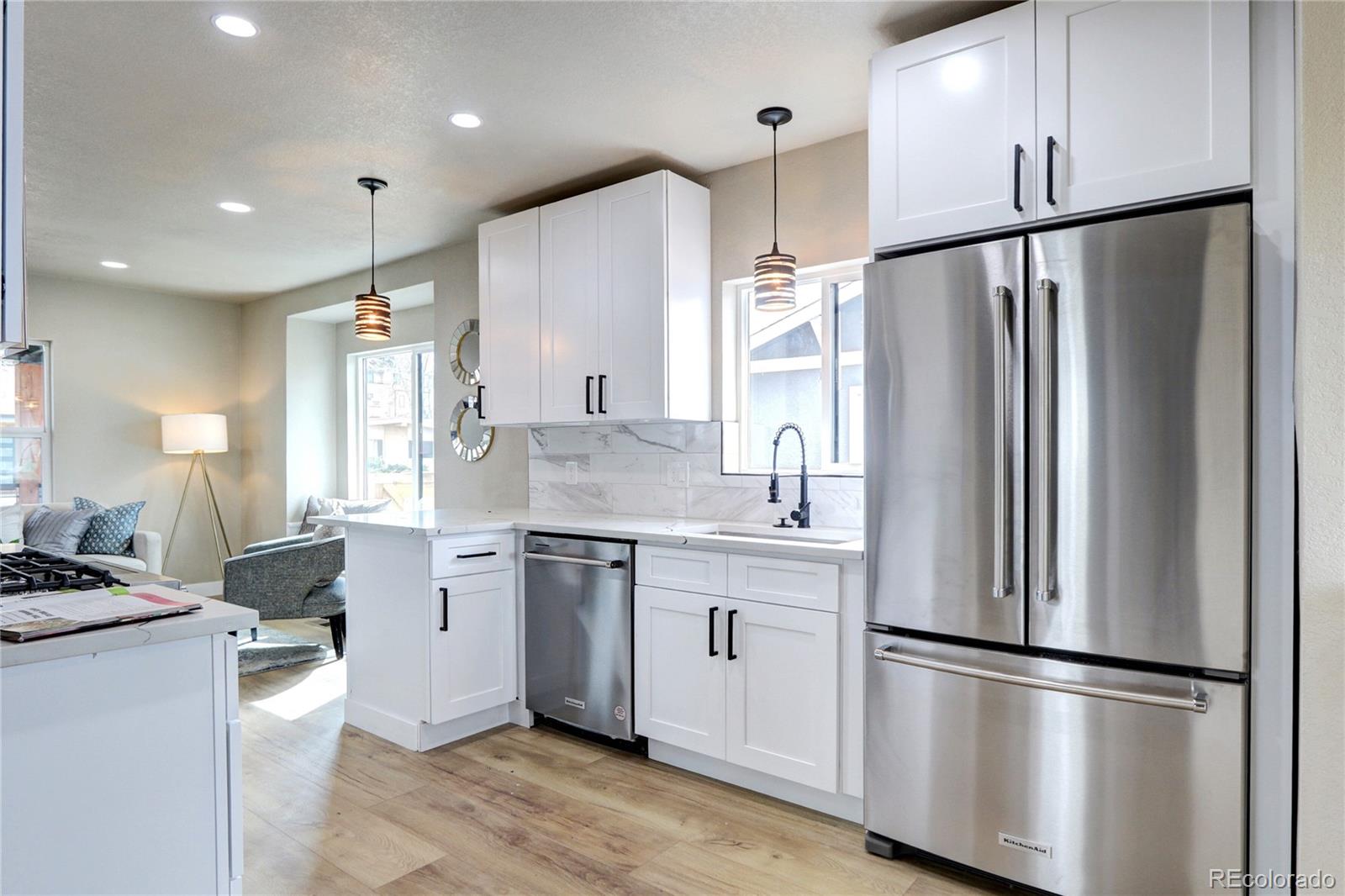2525 South Lincoln Street Denver, CO 80210 - Photo 13 of 38 a kitchen with stainless steel appliances a refrigerator sink and cabinets