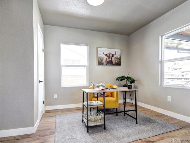 a workspace room with furniture and window