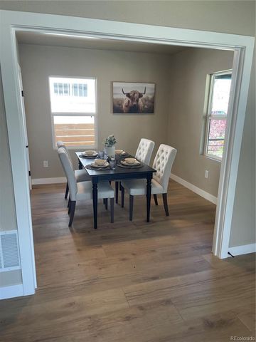 a view of a dining room with furniture and window