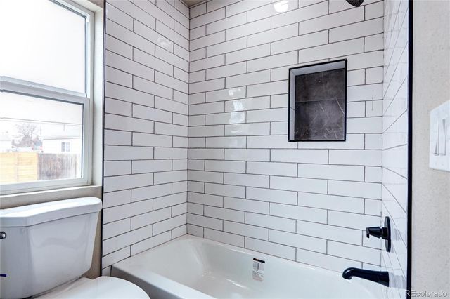 a bathroom with a toilet and a bathtub