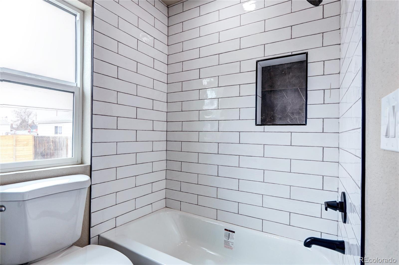 2525 South Lincoln Street Denver, CO 80210 - Photo 19 of 38 a bathroom with a toilet and a bathtub