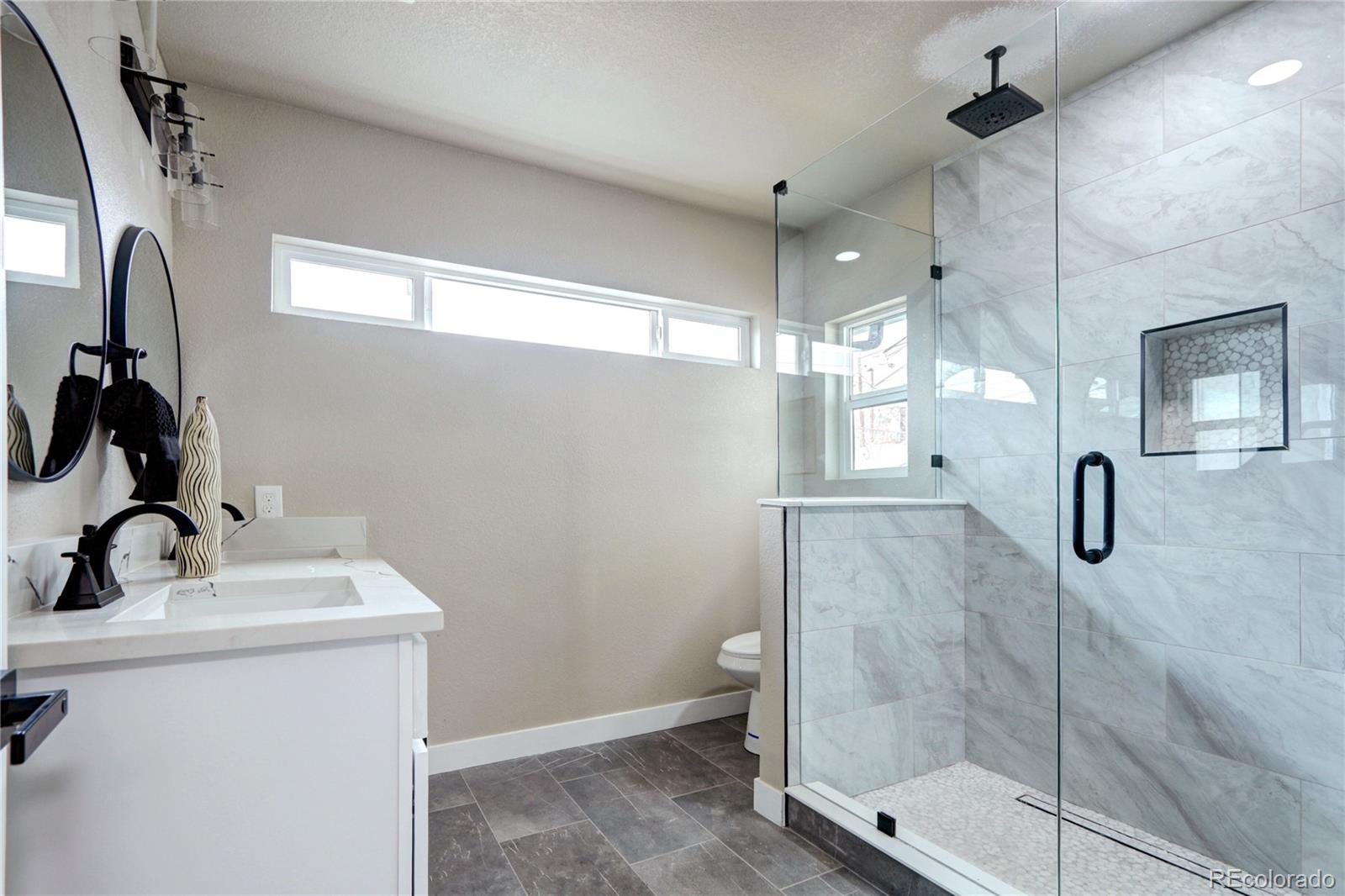2525 South Lincoln Street Denver, CO 80210 - Photo 20 of 38 a bathroom with a sink mirror and shower