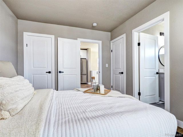 a bedroom with a bed and a mirror