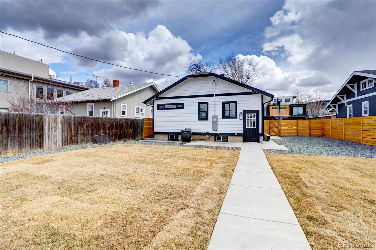 2525 South Lincoln Street Denver, CO 80210 - Photo 32 of 38 a front view of a house with a yard