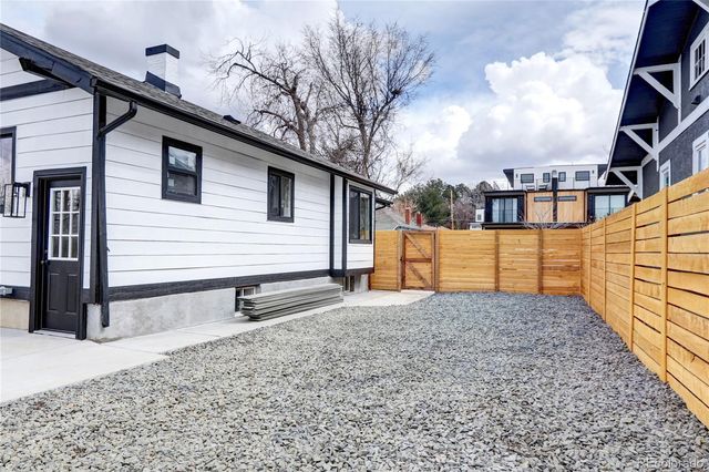 a view of a house with a wooden fence