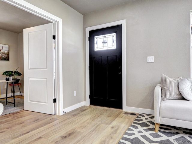 a view of room with furniture and wooden floor