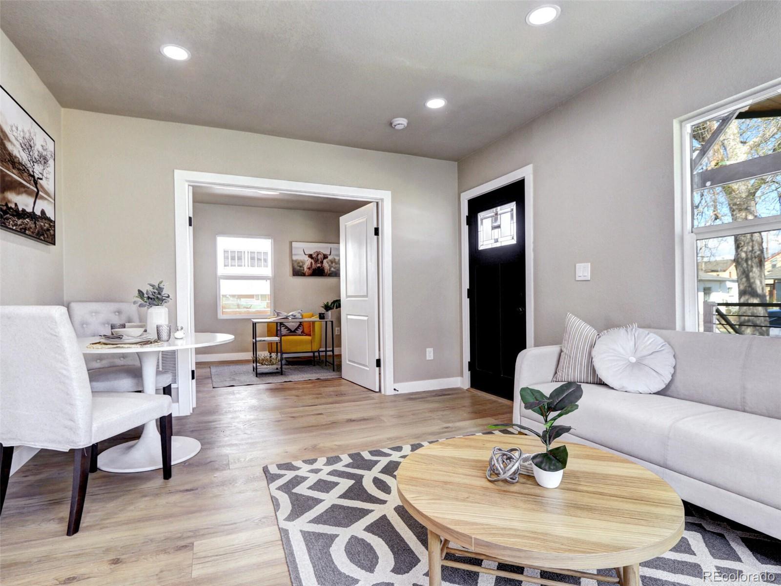 2525 South Lincoln Street Denver, CO 80210 - Photo 5 of 38 a living room with furniture and a dining table with wooden floor