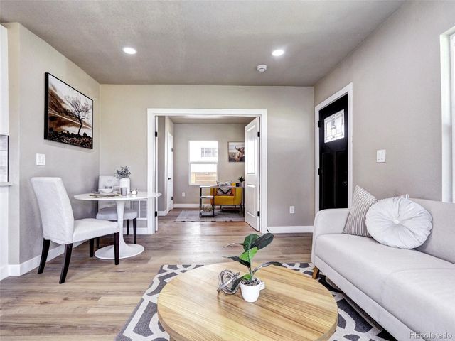 a living room with furniture and wooden floor