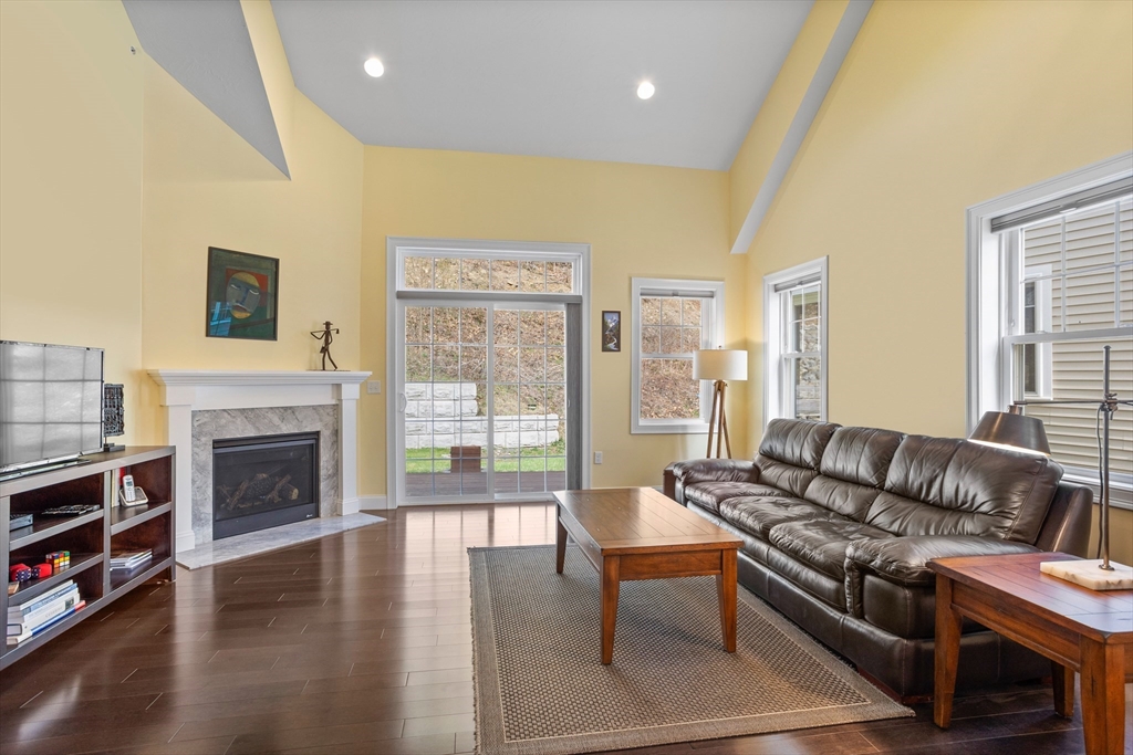 12 Trail Ridge Way, Unit A Harvard, MA 01451 - Photo 14 of 31 a living room with furniture a fireplace and a large window