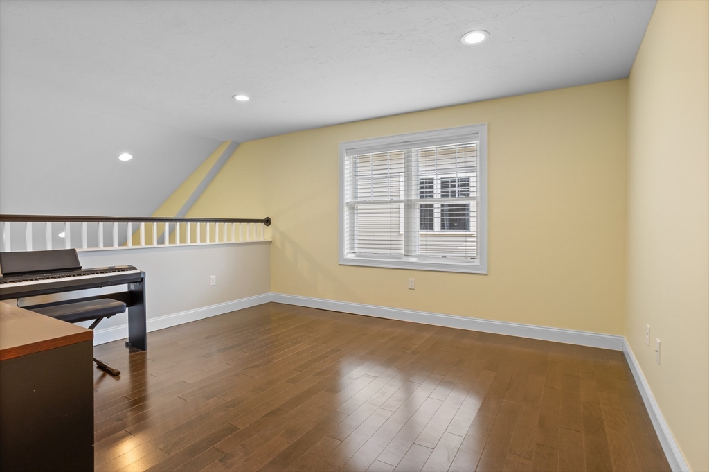 12 Trail Ridge Way, Unit A Harvard, MA 01451 - Photo 22 of 31 a view of an empty room with wooden floor and a window