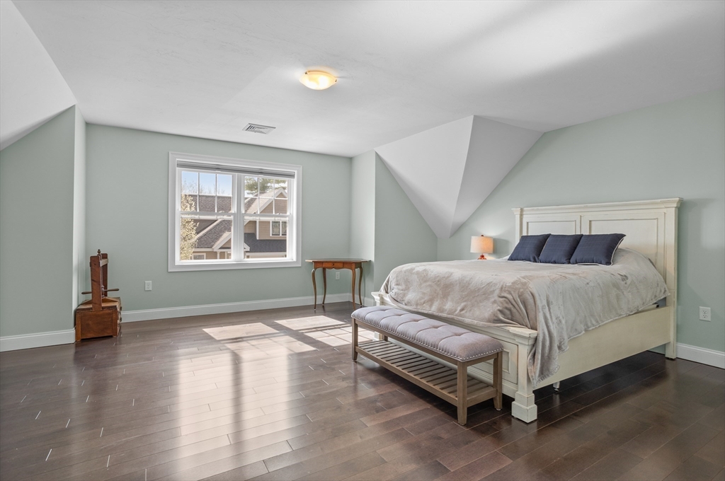 12 Trail Ridge Way, Unit A Harvard, MA 01451 - Photo 23 of 31 a bedroom with a bed and wooden floor