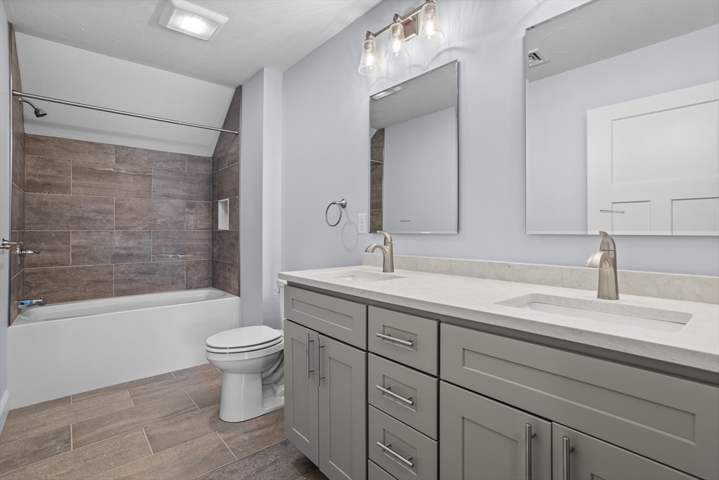 12 Trail Ridge Way, Unit A Harvard, MA 01451 - Photo 25 of 31 a bathroom with a sink toilet a mirror and shower