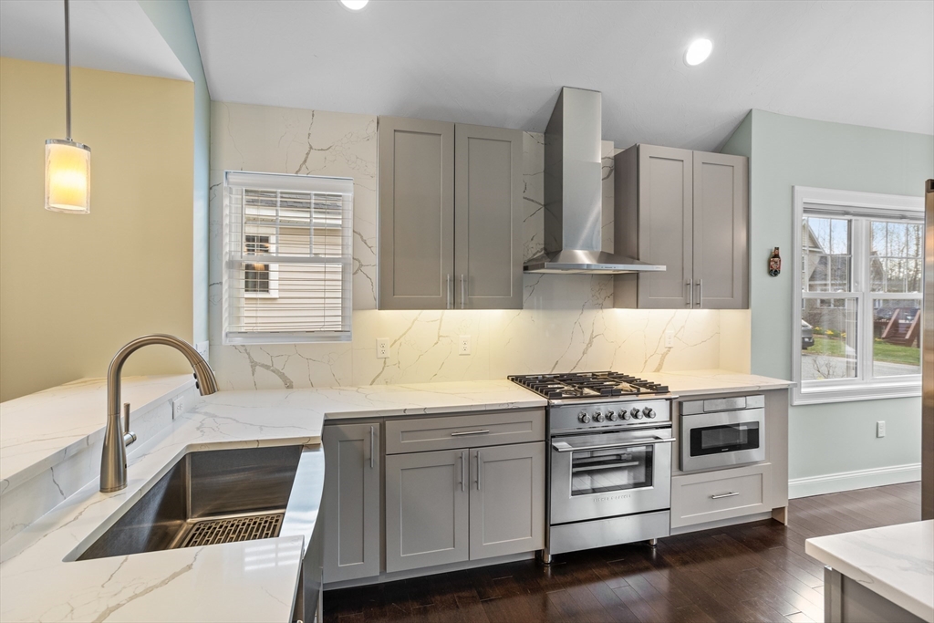 12 Trail Ridge Way, Unit A Harvard, MA 01451 - Photo 6 of 31 a kitchen with stainless steel appliances a stove a sink and a microwave
