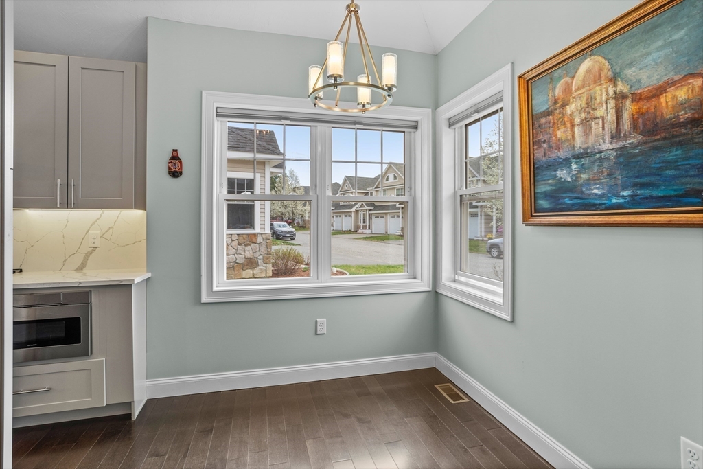 12 Trail Ridge Way, Unit A Harvard, MA 01451 - Photo 7 of 31 a view of an empty room with a window and wooden floor