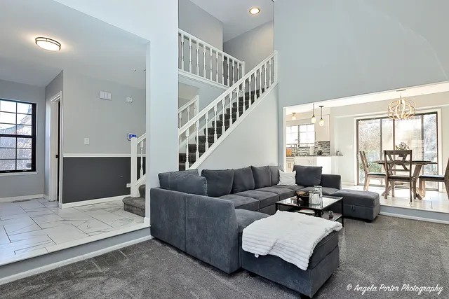 a living room with furniture ceiling fan and a rug