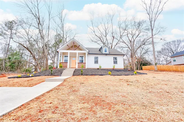a front view of house with yard and trees