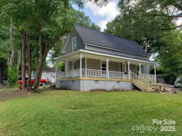 a house view with a sitting space and garden
