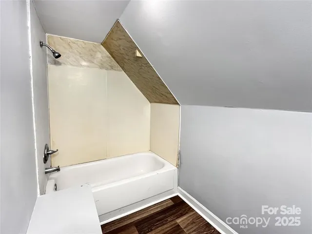 a bathroom with a tub and shower