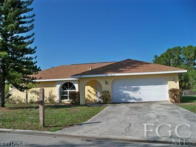7224 Coolidge Road Fort Myers, FL 33967 - Photo 1 of 10 a front view of a house with a yard and garage