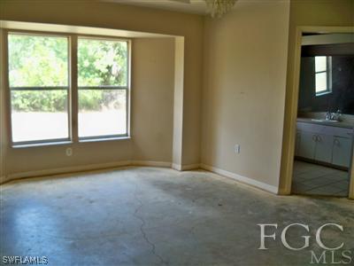 7224 Coolidge Road Fort Myers, FL 33967 - Photo 5 of 10 a view of an empty room with a fireplace and a window