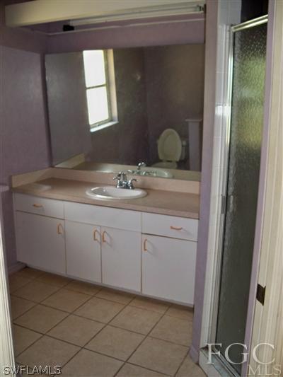 7224 Coolidge Road Fort Myers, FL 33967 - Photo 6 of 10 a bathroom with a granite countertop sink and mirror
