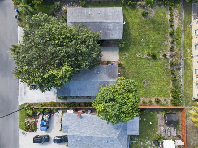 an aerial view of a house with a yard