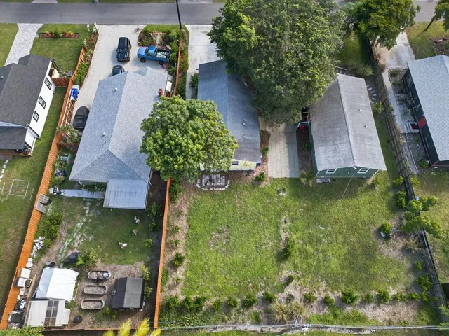 an aerial view of a house with garden space and street view