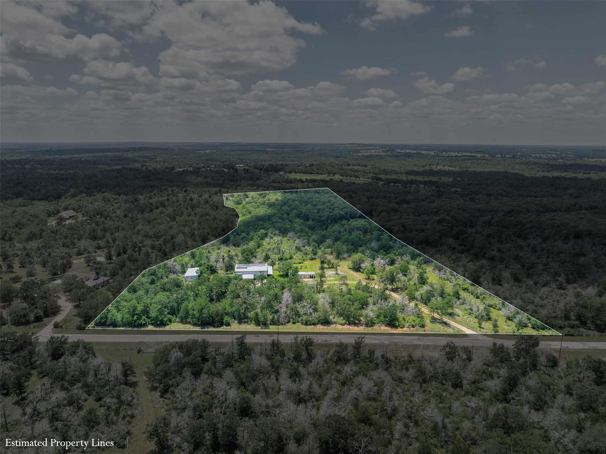 1004 22 Hills Road Gause, TX 77857 - Photo 1 of 37 An aerial perspective reveals a vast, wooded estate bordered by a scenic roadway, showcasing a secluded property line.