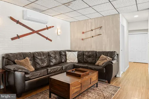 a living room with furniture and a wooden floor