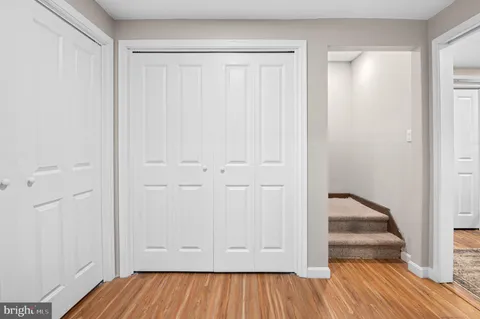 a view of an empty room and wooden floor