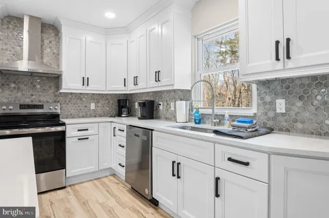 a kitchen with white cabinets and white appliances