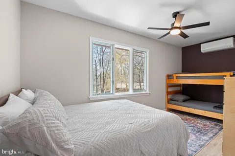 a bedroom with a bed and a ceiling fan