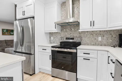 a kitchen with appliances a sink and cabinets