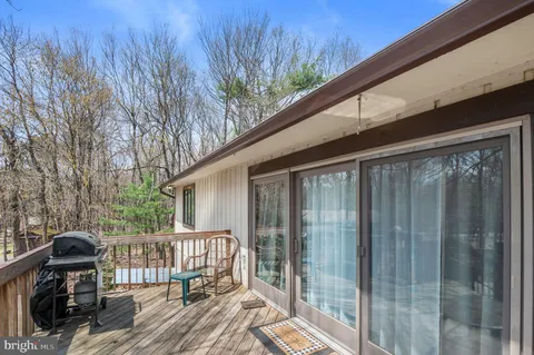 a view of a deck with wooden floor and wooden fence