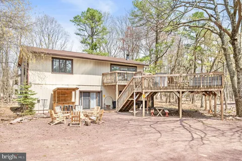 a view of a house with a patio and a slide