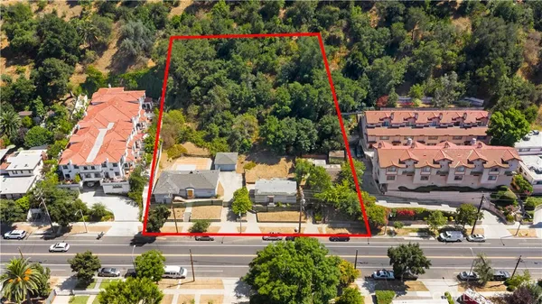 an aerial view of multiple houses with yard