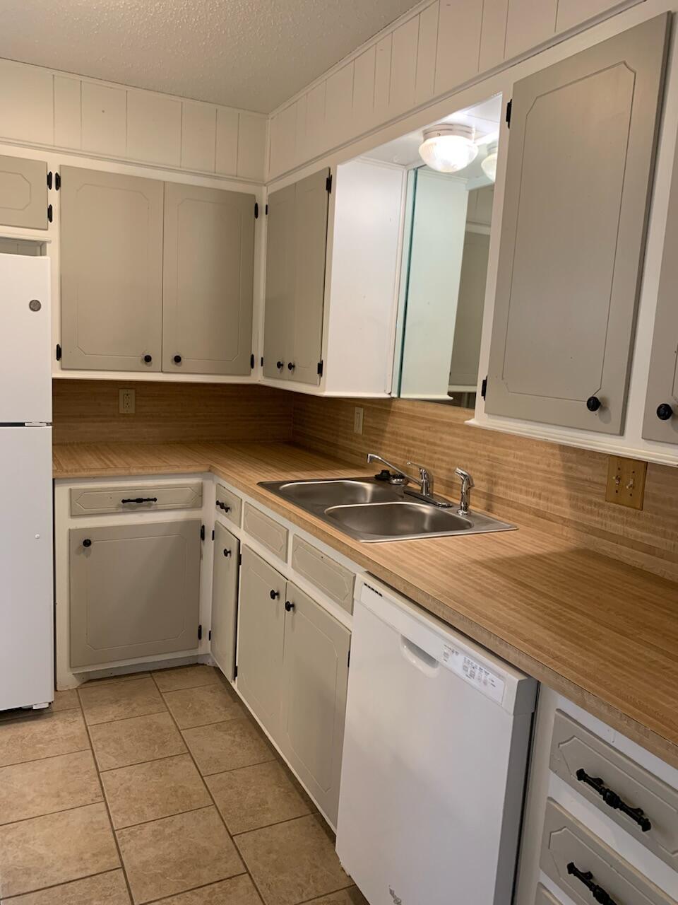 4316 58th Street, Unit B Lubbock, TX 79413 - Photo 18 of 30 a view of a kitchen with white cabinets