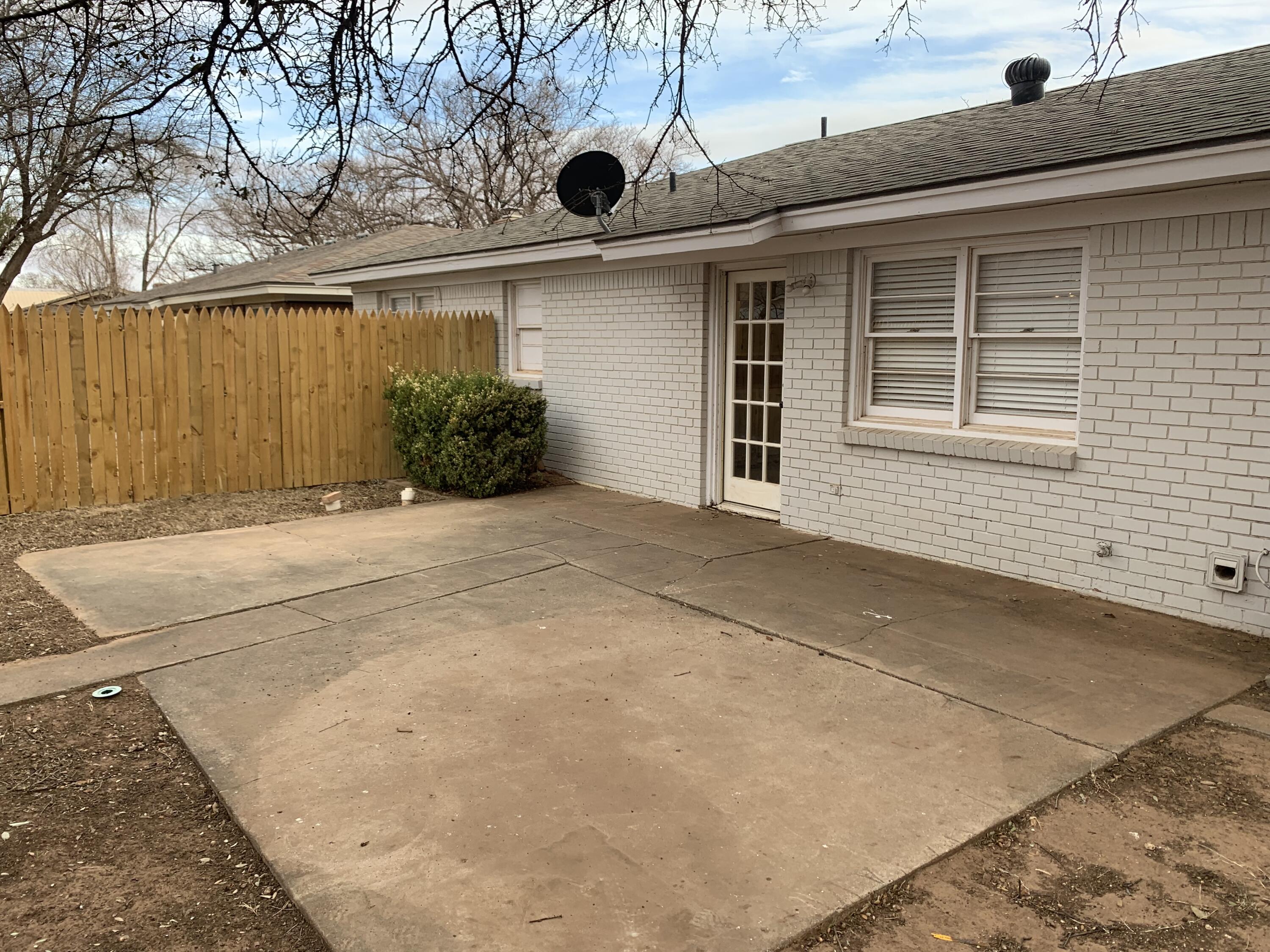 4316 58th Street, Unit B Lubbock, TX 79413 - Photo 19 of 30 a front view of a house with a yard and garage