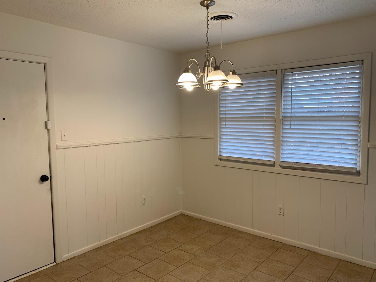 4316 58th Street, Unit B Lubbock, TX 79413 - Photo 22 of 30 a view of a room with a large window and chandelier
