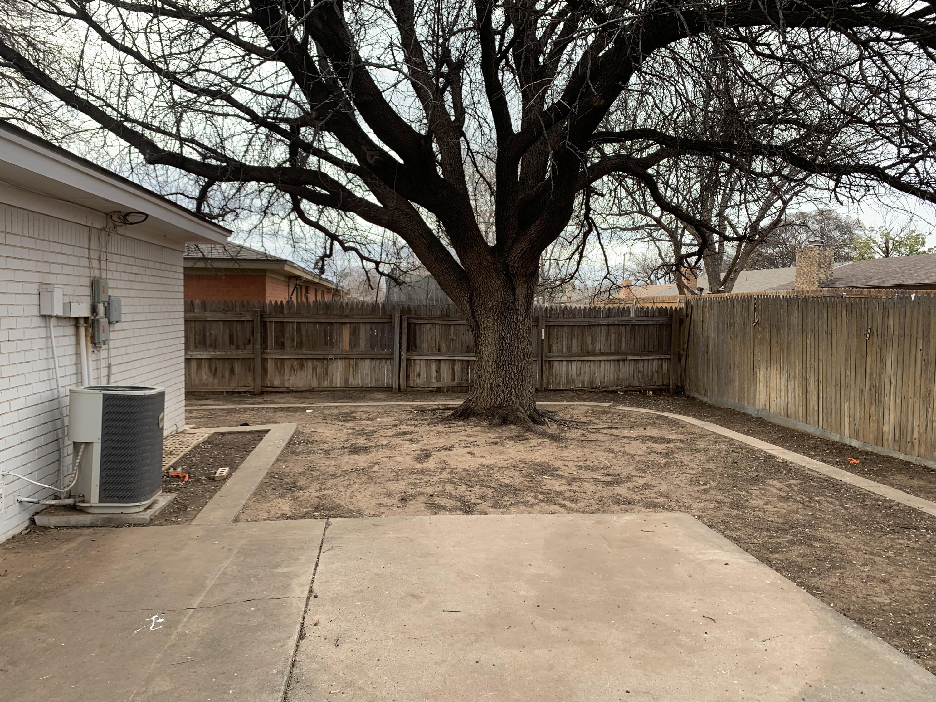 4316 58th Street, Unit B Lubbock, TX 79413 - Photo 26 of 30 a front view of a house with a yard and garage